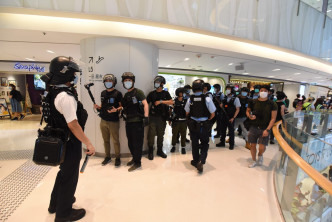 警员驱散商场内人群。黄文威摄