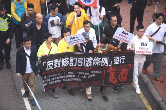游行人士手持印有「反对修订引渡条例」等字眼的黑色横幅