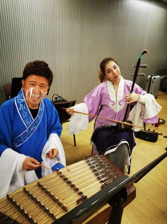 尹光和谢晓莹利用休息时间玩乐器。