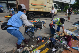 清潔工人在立法會外清理示威者遺下的垃圾。