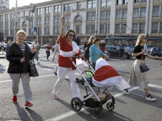 许多妇女手持代表反对派的红白旗。AP相片