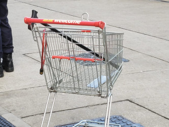 一辆超市手推车载着拐杖及菜刀