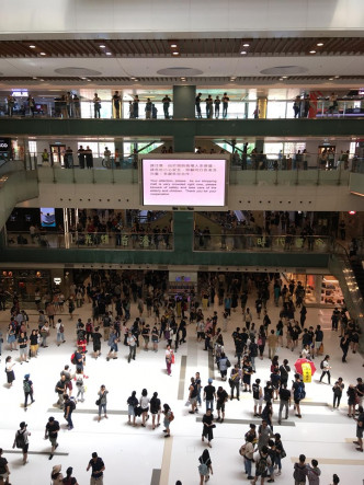 中庭大电视亦显示「现时商场人多挤逼，请各位小心安全」。HelpNewTownPlaza图片