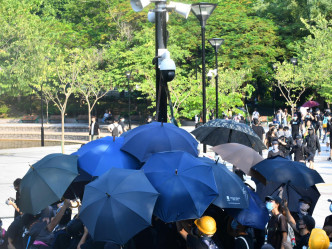 行動期間示威者打開雨傘。