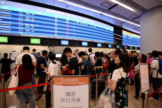 西九龙站大批旅客排队取票买票。