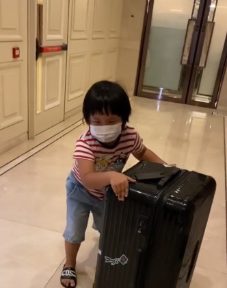 AJ知爸爸工作辛苦，帮佢推行李。