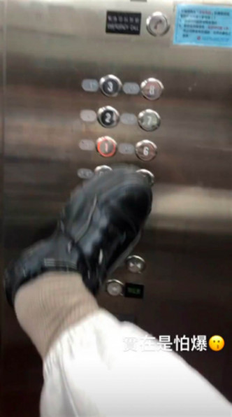 有大學生用用腳按電梯掣。網圖