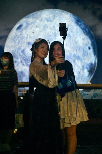 市民紛紛與觀塘海濱的巨型月球合照。