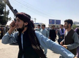塔利班武装分子在机场外围驻守。路透社图片
