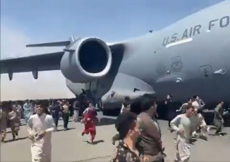 大批民众打算攀附在一架美军军机机身逃亡。网上图片