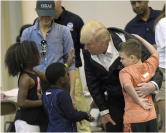 特朗普夫妇表现亲切，与灾民交谈、握手和拥抱。AP