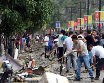 市民合力清理街道上的淤泥。 新華社