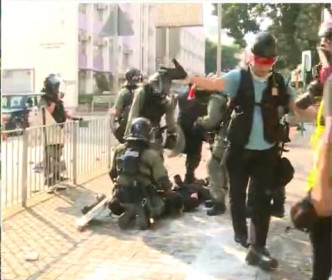 防暴警察制服示威者。無綫新聞