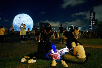 市民纷纷与观塘海滨的巨型月球合照。