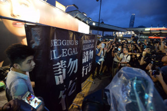 抗議者手持寫上「請勿行乞」的大型橫額。黃賢創攝