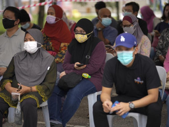 马来西亚总理毛希丁宣布第一阶段全面防疫封锁措施将二度延长。美联社资料图片