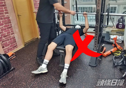 仰臥推舉:錯誤動作--利用史密夫架進行仰臥推舉,容易出現雙手不平均分配以及腳未著地等錯誤動作。 陶法德攝
