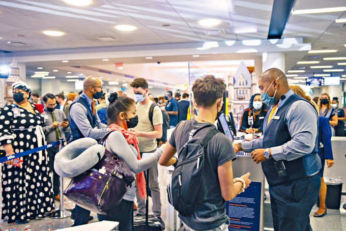 ■乘客在纽约甘乃迪国际机场出示护照。