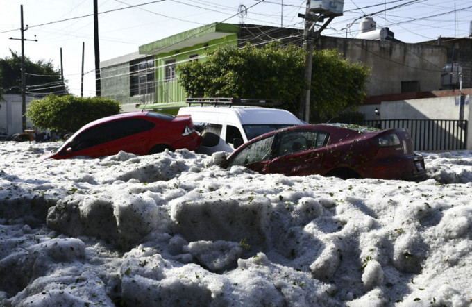 正值盛夏的墨西哥大城瓜达拉哈拉突然降下一场夸张的冰雹，留下了深达2米的积冰。AP
