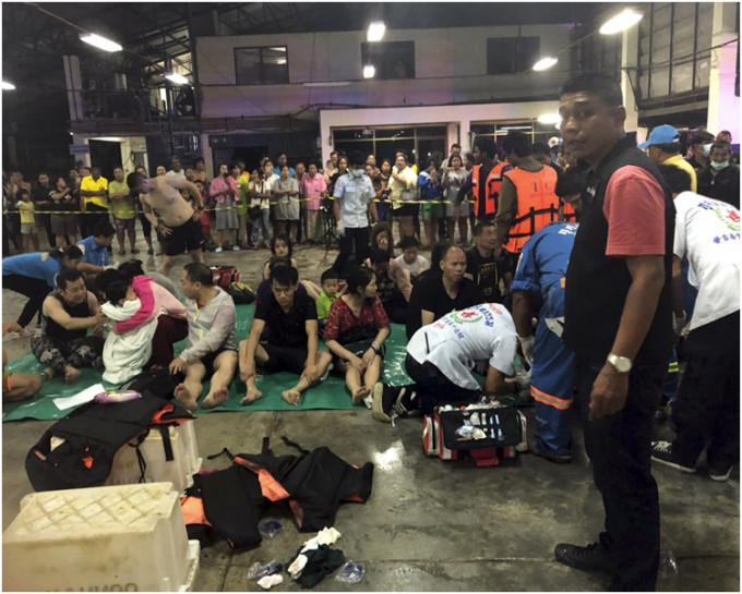 游客获救后被安置在码头等待送院。 AP