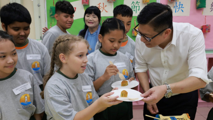 保安局局长邓炳强趁住佳节前去到长者邻舍中心及少数族裔学校，与他们分享吃传统月饼的喜悦。（邓炳强FB图片）