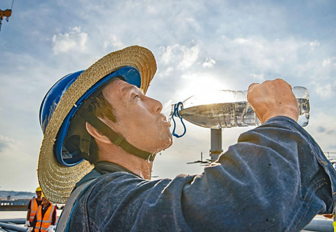 重慶室外工人在烈日下補水。