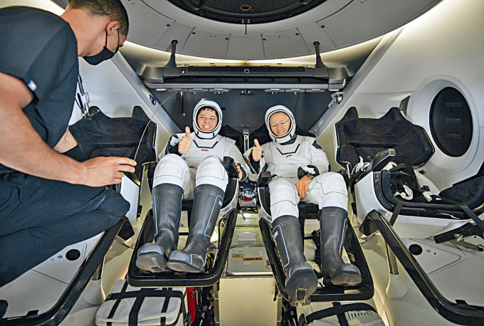 降落后太空人赫尔利（右）和本肯准备离开飞船。　