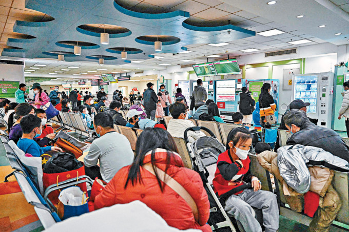 儿童和父母们昨日挤在北京某儿童医院候诊。