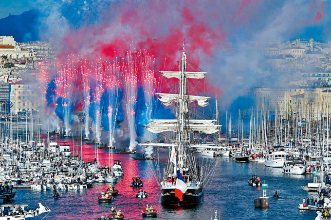 運載奧運聖火火種的貝勒姆號周三抵達馬賽老港時，煙花燃放。