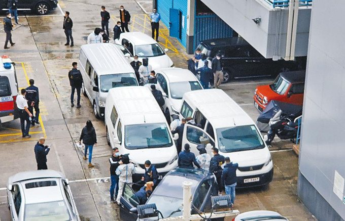  穿上白色保護衣的七名疑犯，日前在內地落網後昨移交香港警方及押返警署。