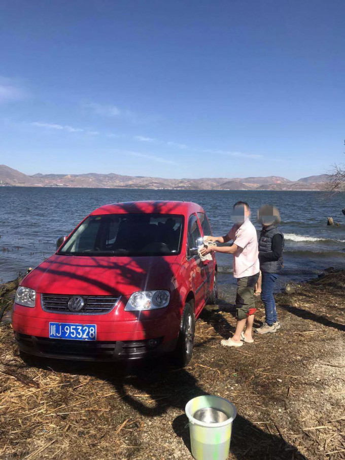 張男自駕至大理遊玩時在大理洱海邊洗車相被人拍下放上網。