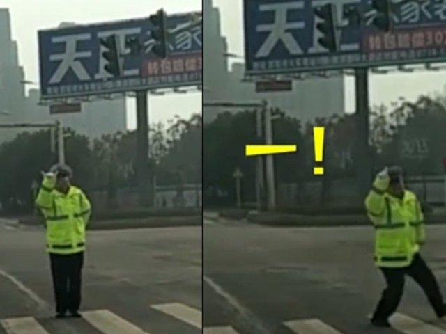 湖南一名交通警察自創「手勢舞」，在當地一個沒有讀秒功能的交通燈路口，邊跳邊提示司機和路人。 網上圖片