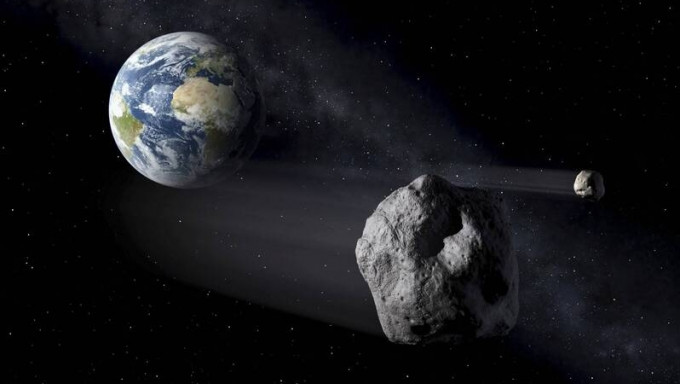 小行星掠过地球模拟图。 美联社
