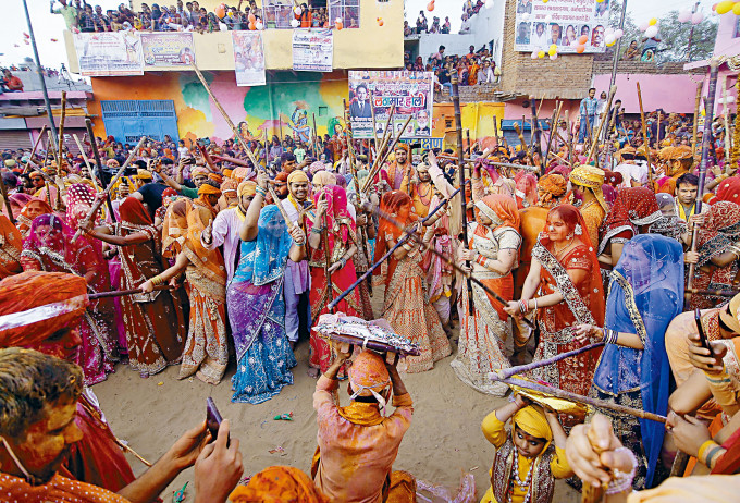 印度北方邦一個村莊的印度教信徒周三聚在一起，用竹杆作狀打男性，慶祝傳統「棒打男人節」。