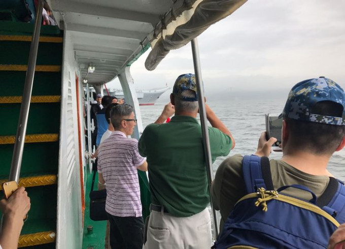當接駁船靠近航母時，市民愈見興奮，連忙拿出手機拍下整個遼寧艦的風采。