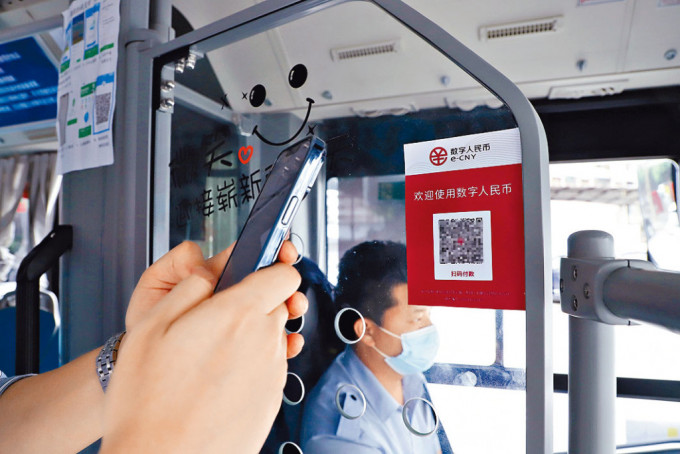 重庆乘客使用数码人民币乘坐公共巴士。