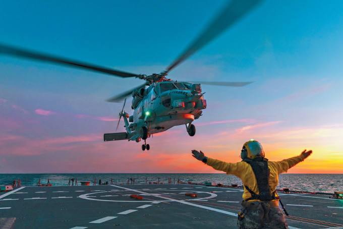 一架澳州海军「海鹰」直升机准备降落在「霍巴特号」航母的甲板上。