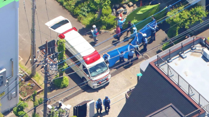 警員在校內拉起帆布，有救護車到場。 法新社