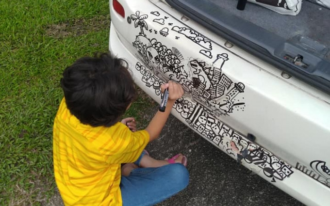 小女孩正在涂鸦车子。Ahmad Farid Ashraf FB