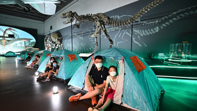 参加者于展览厅内恐龙化石下架设的帐篷留宿。政府新闻处图片