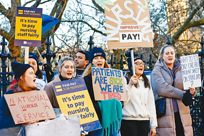 护士周一在伦敦的圣托马斯医院门外示威，要求政府加薪抗通胀。