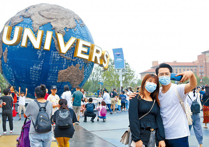 ■遊客昨天在北京環球度假區的標誌性景觀前拍照留影。