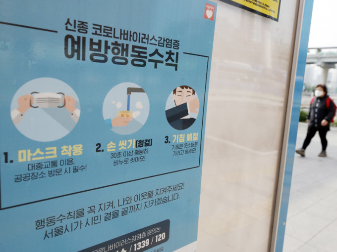 南韓今日起要求民眾乘坐公共交通工具時必須配戴口罩，巴士站上亦有宣傳。AP圖