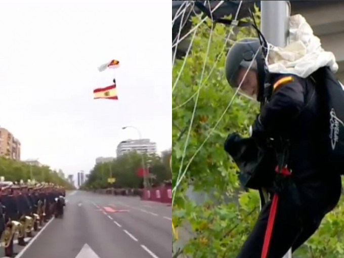 西班牙國慶閱兵上，傘兵攜帶國旗從天而降，向前來觀禮的國王致敬，惟撞上一旁路燈並掛在上面。（網圖）