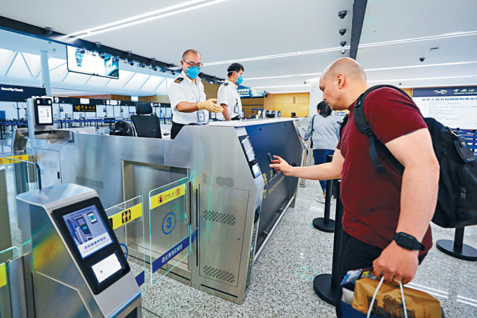 成都国际机场关员为外国旅客办理入境手续。