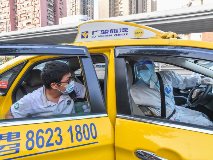 的士司機全副防疫裝備於廣州高風險區域接送高考生。新華社
