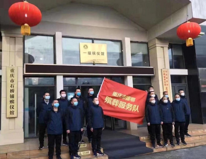 網上流傳一張重慶援鄂支援湖北「殯葬服務隊」手舉旗幟的合影。(網圖)