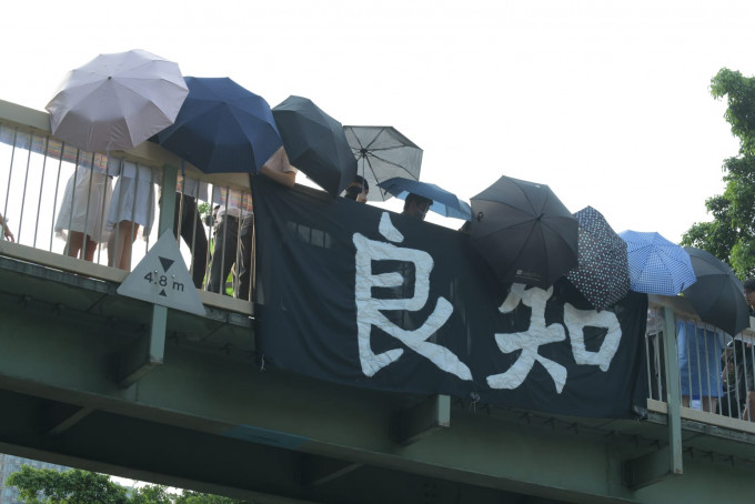 有学生在天桥上挂上「良知」的横额。