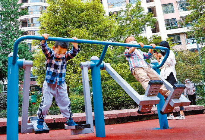 上海疫情趋缓，两名男孩在普陀区的一个居民小区内玩耍。