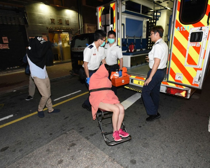 女子由男友陪同下乘救护车送院检验。